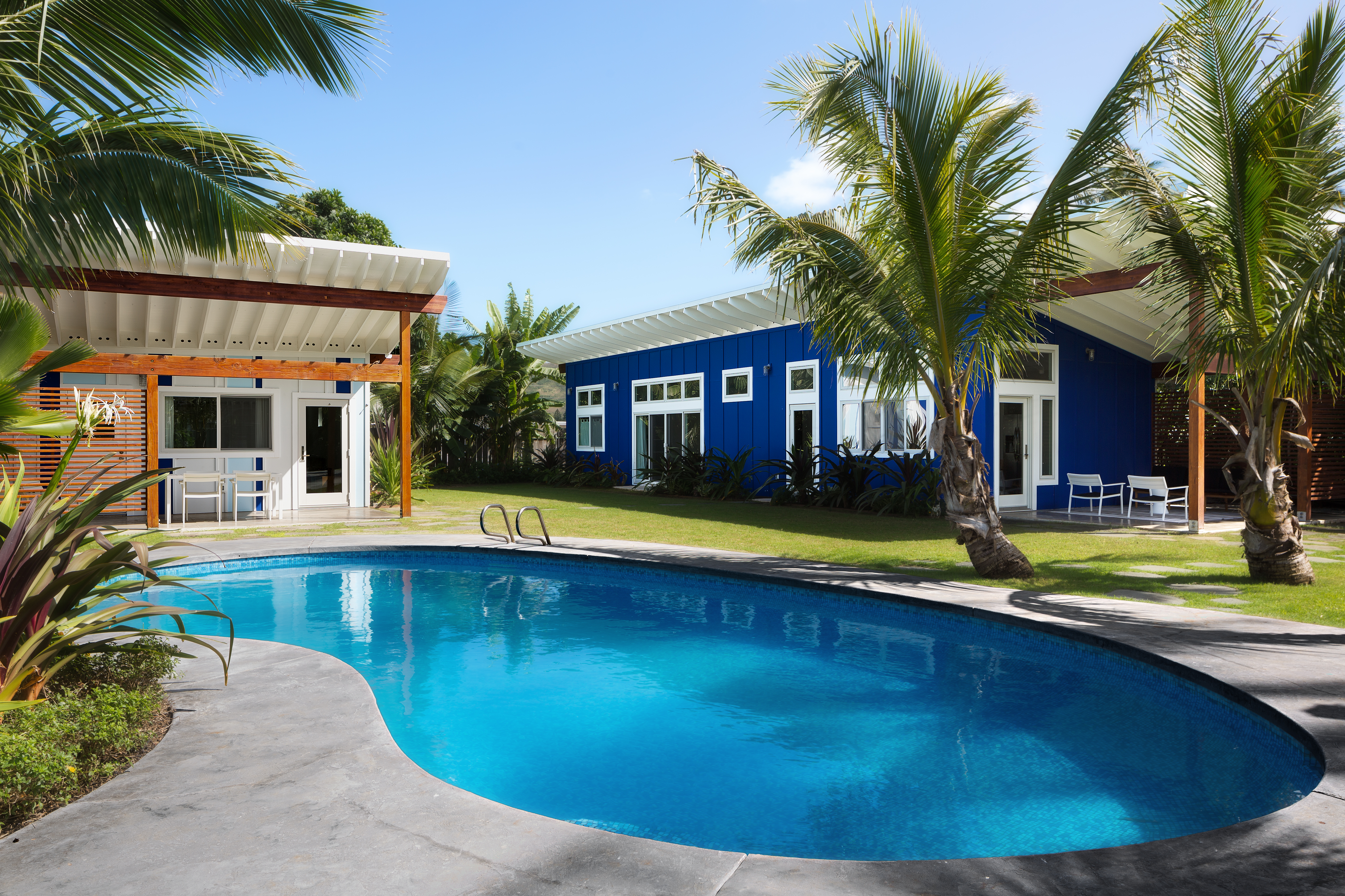 Hale Kilo Ia residence arranged around a pool and tropical landscape