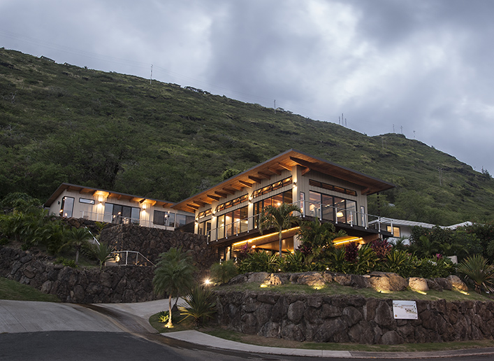 Wailupe Gulch House illuminated against a steep green mountainside